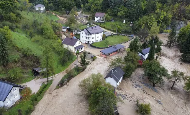 Flooded houses after a heavy rain in the village of Luke, near Bosnian town of Fojnica, 50 kms west of Sarajevo, Bosnia, Friday, Oct. 4, 2024. (AP Photo/Robert Oroz)