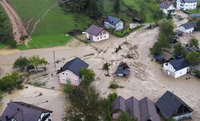 Flooded houses is seen after a heavy rain in the village of Luke, near Bosnian town of Fojnica , 50 kilometers (31 miles) west of Sarajevo, Bosnia, Friday, Oct. 4, 2024. (AP Photo/Robert Oroz)