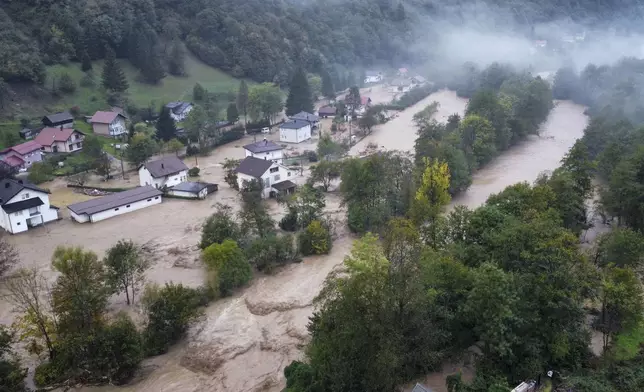 Flooded houses is seen after a heavy rain in the village of Luke, near Bosnian town of Fojnica , 50 kilometers (31 miles) west of Sarajevo, Bosnia, Friday, Oct. 4, 2024. (AP Photo/Robert Oroz)