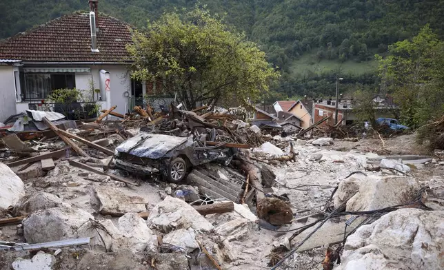 A damaged car is seen after flood hit the village of Donja Jablanica, Bosnia, Saturday, Oct. 5, 2024. (AP Photo/Armin Durgut)