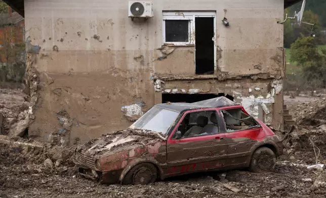 A car is seen covered in mud following flash floods and landslides in Donja Jablanica, Bosnia, Thursday, Oct. 24, 2024. (AP Photo/Armin Durgut)