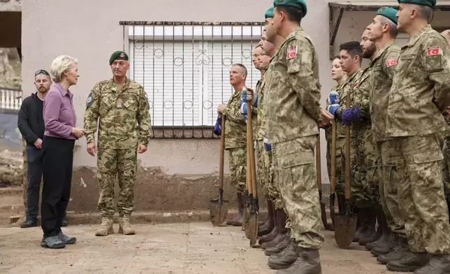 European Commission president Ursula von der Leyen talks to Eufor soldiers during her visit to the area that was recently hit by floods and landslides, in Jablanica, Bosnia, Thursday, Oct. 24, 2024.(AP Photo/Armin Durgut)