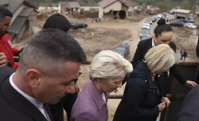 European Commission president Ursula von der Leyen, centre, visits the area which was recently hit by floods and landslides in Jablanica, Bosnia, Thursday, Oct. 24, 2024.(AP Photo/Armin Durgut)