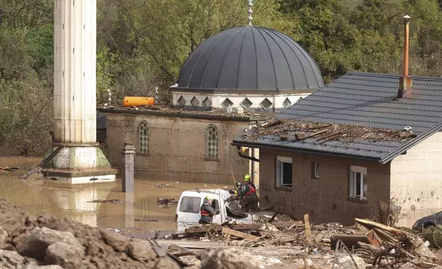 Rescuers search for missing people after floods and landslides hit the village of Donja Jablanica, Bosnia, Saturday, Oct. 5, 2024. (AP Photo/Armin Durgut)