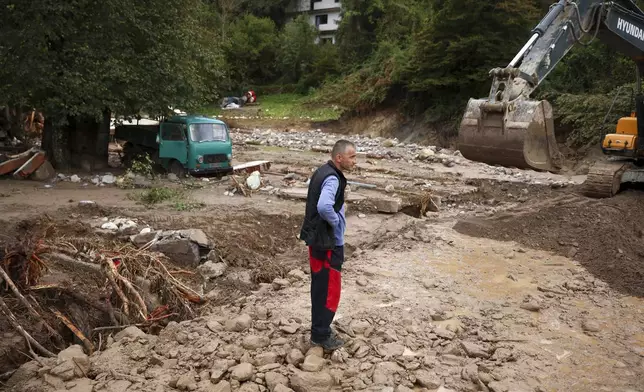 A man stands among destroyed homes following a flooding in Buturovic Polje, Bosnia, Sunday, Oct. 6, 2024. (AP Photo/Armin Durgut)