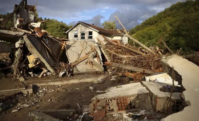 Homes sit destroyed by torrential rain and flooding in Buturovic Polje, Bosnia, Sunday, Oct. 6, 2024. (AP Photo/Armin Durgut)