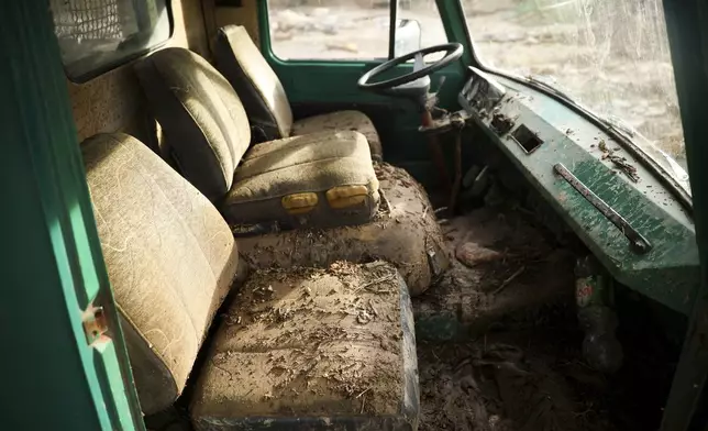 A truck is covered in mud following torrential rain and flooding in Buturovic Polje, Bosnia, Sunday, Oct. 6, 2024. (AP Photo/Armin Durgut)