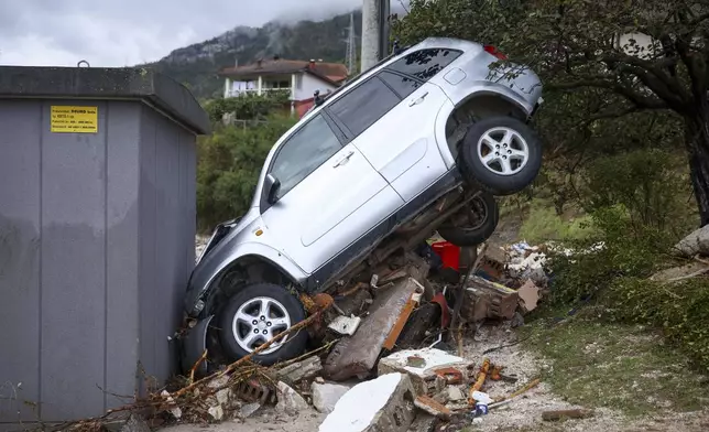 A damaged car is seen after flood hit the village of Donja Jablanica, Bosnia, Saturday, Oct. 5, 2024. (AP Photo/Armin Durgut)