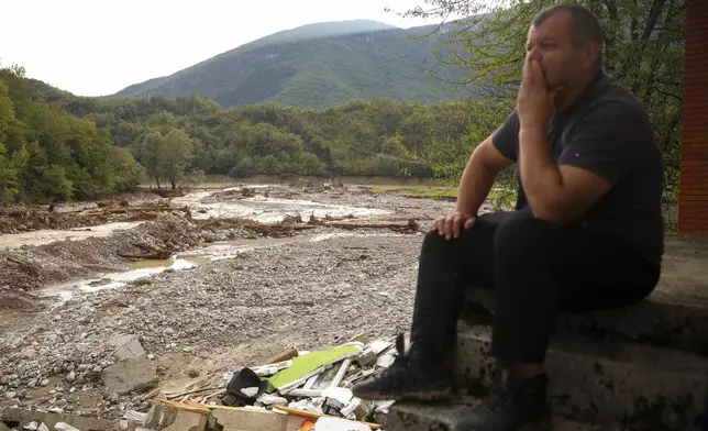 A man reacts as he looks at the destroyed houses following flooding in village of Buturovic Polje, Bosnia, Sunday, Oct. 6, 2024. (AP Photo/Armin Durgut)