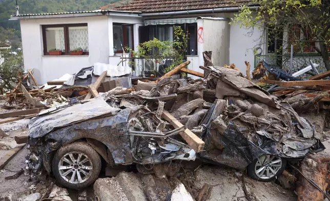 A damaged car is seen after flood hit the village of Donja Jablanica, Bosnia, Saturday, Oct. 5, 2024. (AP Photo/Armin Durgut)