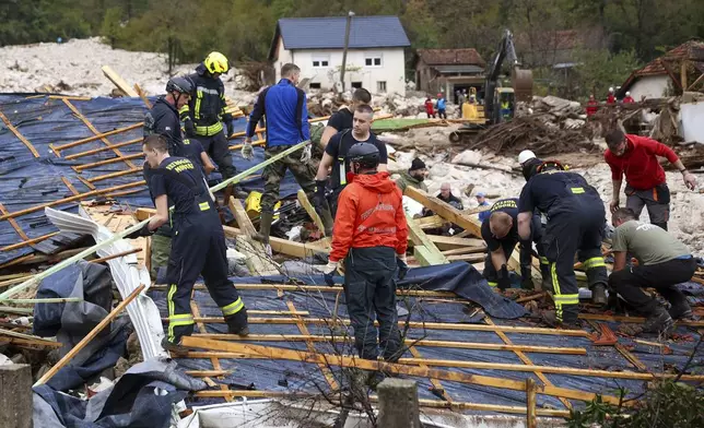 Rescuers search for missing people after floods and landslides in the village of Donja Jablanica, Bosnia, Saturday, Oct. 5, 2024. (AP Photo/Armin Durgut)