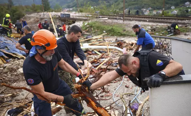 Rescuers search for missing people after floods and landslides in the village of Donja Jablanica, Bosnia, Saturday, Oct. 5, 2024. (AP Photo/Armin Durgut)