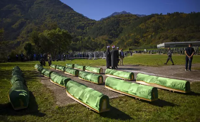 Coffins are prepared for the funeral of 19 victims of recent floods in Jablanica, Bosnia, Tuesday, Oct. 15, 2024. (AP Photo/Armin Durgut)