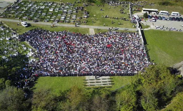 An aerial view of the collective funeral for 19 victims of a landslide caused by recent floods in Jablanica, Bosnia, Tuesday, Oct. 15, 2024. (AP Photo/Armin Durgut)