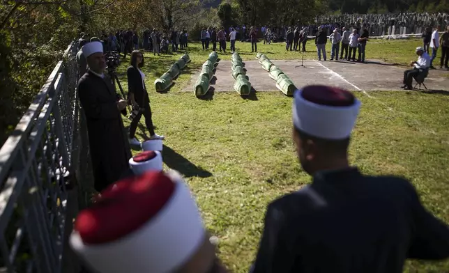 Coffins are prepared for the funeral of 19 victims of recent floods in Jablanica, Bosnia, Tuesday, Oct. 15, 2024. (AP Photo/Armin Durgut)