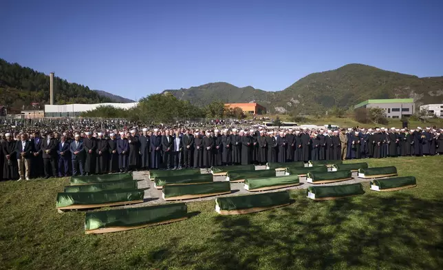 Imams and mourners attend the collective funeral for 19 victims of a landslide caused by recent floods in Jablanica, Bosnia, Tuesday, Oct. 15, 2024. (AP Photo/Armin Durgut)