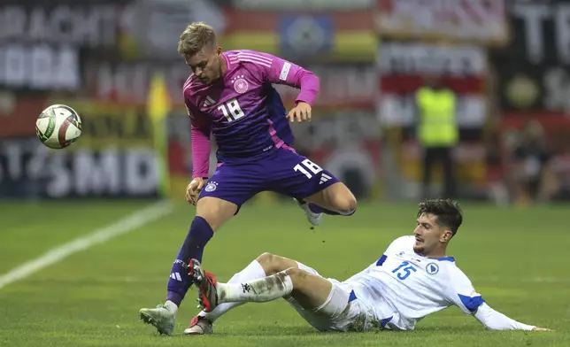 Bosnia's Armin Gigovic tackles Germany's Maximilian Mittelstadt during the Nations League soccer match between Bosnia and Germany in Zenica, Bosnia and Herzegovina, on Friday, Oct. 11, 2024. (AP Photo/Armin Durgut)