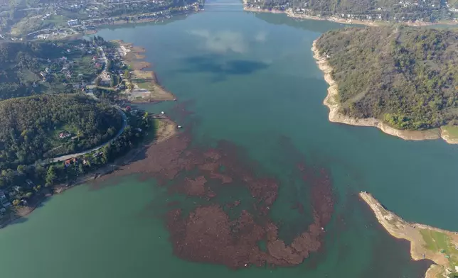 Aerial view mud and waste floating on Jablanicko lake after devastating floods and landslides near Ostrozac, Bosnia, Sunday, Oct. 20, 2024. (AP Photo/Armin Durgut)