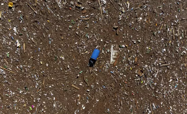 Aerial view of waste stuck at the dam on the Neretva river caused by landslides, torrential rain and flash floods in Grabovica, Bosnia, Sunday, Oct. 13, 2024. (AP Photo/Armin Durgut)