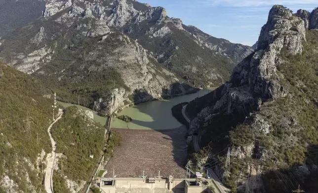 Aerial view of waste stuck at the dam on the Neretva river caused by landslides, torrential rain and flash floods in Grabovica, Bosnia, Sunday, Oct. 13, 2024. (AP Photo/Armin Durgut)