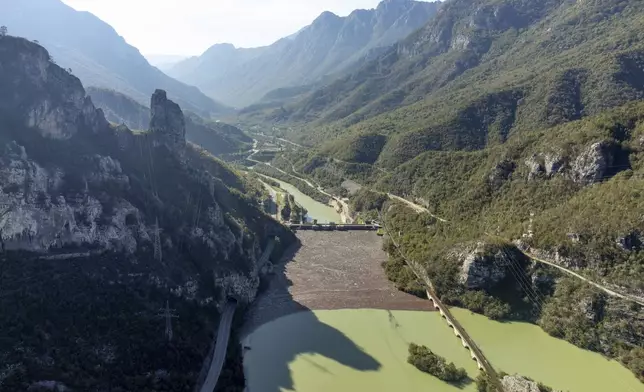 Aerial view of waste stuck at the dam on the Neretva river caused by landslides, torrential rain and flash floods in Grabovica, Bosnia, Sunday, Oct. 13, 2024. (AP Photo/Armin Durgut)