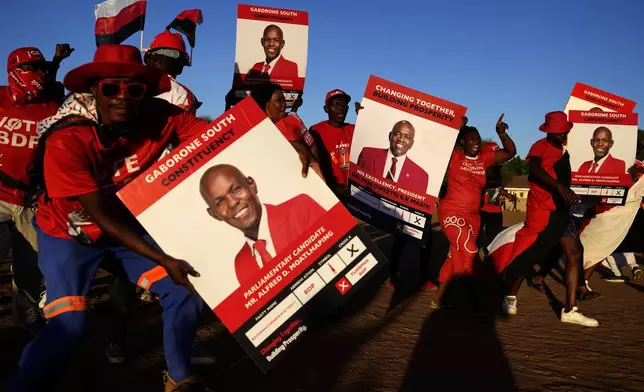 Members of the Botswana Democratic Party sing and dance as they arrive for their election rally, a day before elections in Gaborone, Botswana, Tuesday, Oct. 29, 2024. (AP Photo/Themba Hadebe)