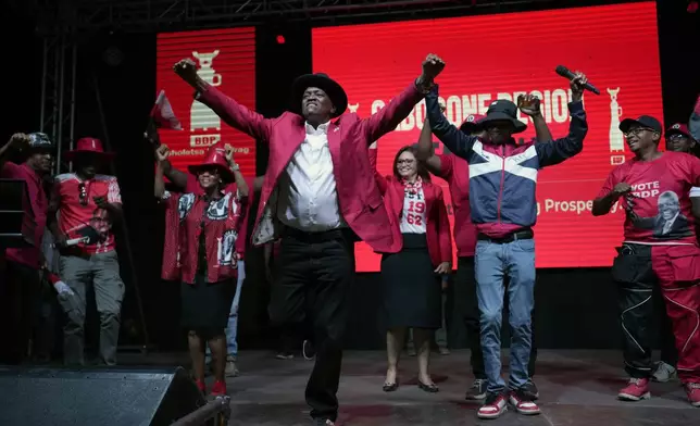 Botswana Democratic Party president Mokgweetsi Masisi dances during his election rally, a day before elections in Gaborone, Botswana, Tuesday, Oct. 29, 2024. (AP Photo/Themba Hadebe)