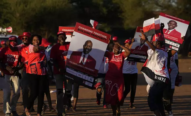 Members of the Botswana Democratic Party sing and dance as they arrive for their election rally, a day before elections in Gaborone, Botswana, Tuesday, Oct. 29, 2024. (AP Photo/Themba Hadebe)