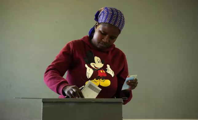 A woman casts her vote during the elections in Gaborone, Botswana, Wednesday, Oct. 30, 2024. (AP Photo/Themba Hadebe)