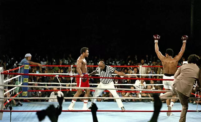 FILE - Challenger Muhammad Ali raises his arms in victory after defending champion George Foreman is counted out by referee Zack Clayton, ending the WBA/WBC championship bout in Kinshasa, Zaire, on Oct. 30, 1974. (AP Photo, File)