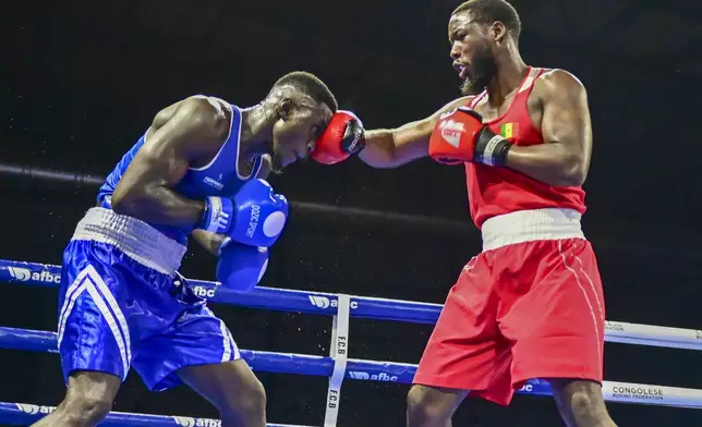 Senegal's Karamba Kebe, right, wins the African boxing championship final against Congo's Landry Matete Kankonde in Kinshasa, Democratic Republic of the Congo, Saturday, Oct. 26, 2024. (AP Photo/Samy Ntumba Shambuyi)