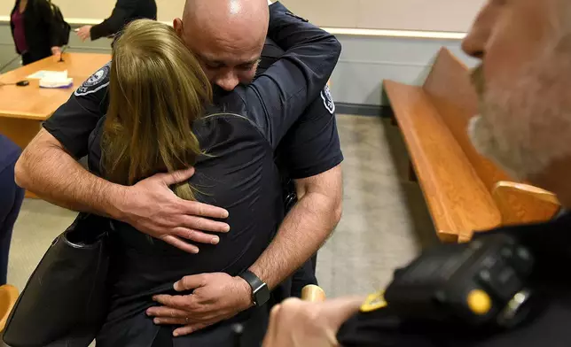 Assistant Attorney General Meghan Hagaman gets a hug from Merrimack Police Chief Brian Levesque following the sentencing of Danielle Dauphinais at Hillsborough County Superior Court South in Nashua, N.H., on Friday, Oct. 25, 2024. (David Lane/Union Leader via AP, Pool)