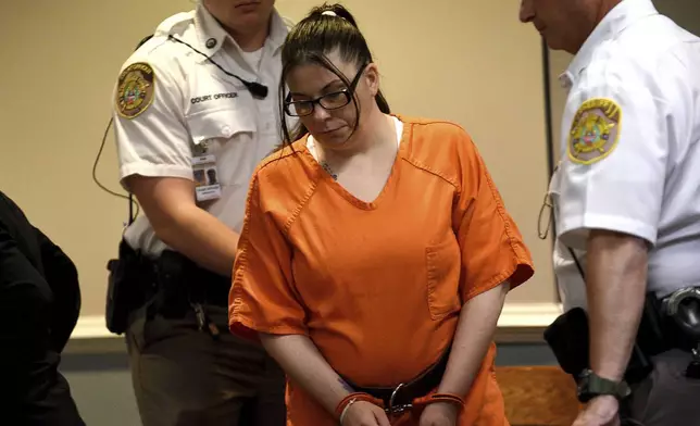 Danielle Dauphinais, who pleaded guilty last month to second-degree murder and other charges in the death of her 5-year old son Elijah Lewis in 2021, gets escorted to her table at her sentencing hearing at Hillsborough County Superior Court South in Nashua, N.H., on Friday, Oct. 25, 2024. (David Lane/Union Leader via AP, Pool)