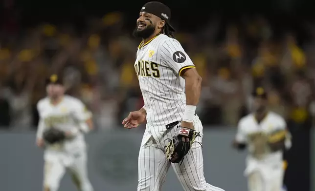 San Diego Padres' Fernando Tatis Jr. smiles after a win over the Atlanta Braves in Game 2 of an NL Wild Card Series baseball game Wednesday, Oct. 2, 2024, in San Diego. (AP Photo/Gregory Bull)