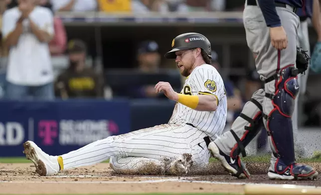 San Diego Padres' Jake Cronenworth scores on a sacrifice fly ball from Kyle Higashioka during the second inning in Game 1 of an NL Wild Card Series baseball game against the Atlanta Braves, Tuesday, Oct. 1, 2024, in San Diego. (AP Photo/Gregory Bull)