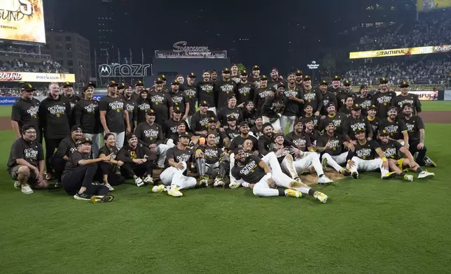 The San Diego Padres pose for a team photo after defeating the Atlanta Braves in Game 2 of an NL Wild Card Series baseball game Wednesday, Oct. 2, 2024, in San Diego. (AP Photo/Gregory Bull)