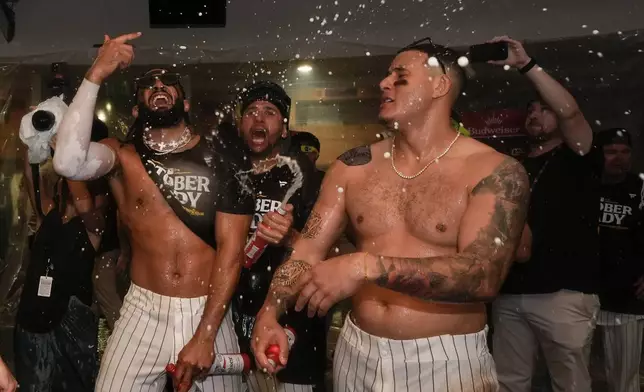 San Diego Padres players celebrate in the dugout after defeating the Atlanta Braves in Game 2 of an NL Wild Card Series baseball game Wednesday, Oct. 2, 2024, in San Diego. (AP Photo/Gregory Bull)