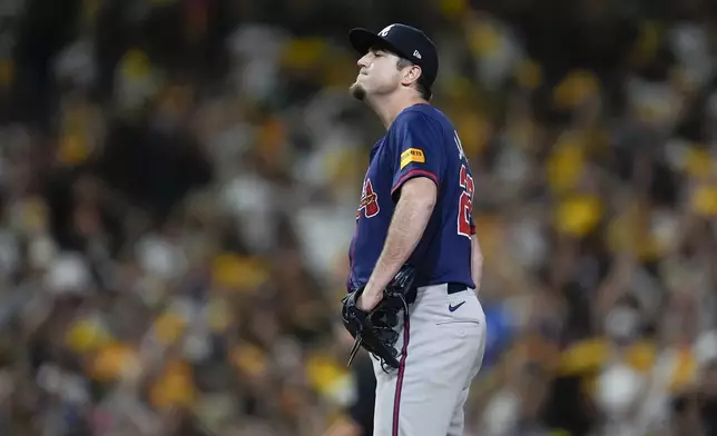 Atlanta Braves pitcher Luke Jackson stands on the mound after giving up a solo home run to San Diego Padres' Kyle Higashioka during the eighth inning in Game 1 of an NL Wild Card Series baseball game Tuesday, Oct. 1, 2024, in San Diego. (AP Photo/Gregory Bull)