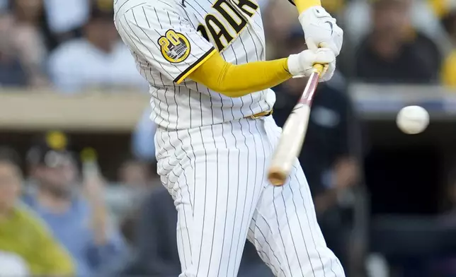 San Diego Padres' Kyle Higashioka connects for a solo home run during the second inning in Game 2 of an NL Wild Card Series baseball game against the Atlanta Braves, Wednesday, Oct. 2, 2024, in San Diego. (AP Photo/Gregory Bull)