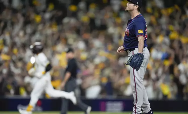 Atlanta Braves pitcher Luke Jackson stands on the mound after giving up a solo home run to San Diego Padres' Kyle Higashioka during the eighth inning in Game 1 of an NL Wild Card Series baseball game Tuesday, Oct. 1, 2024, in San Diego. (AP Photo/Gregory Bull)