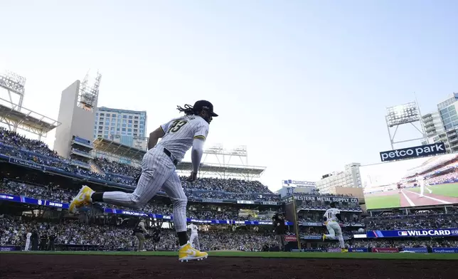 San Diego Padres' Fernando Tatis Jr. runs onto the field at the start of Game 1 of an NL Wild Card Series baseball game against the Atlanta Braves, Tuesday, Oct. 1, 2024, in San Diego. (AP Photo/Gregory Bull)