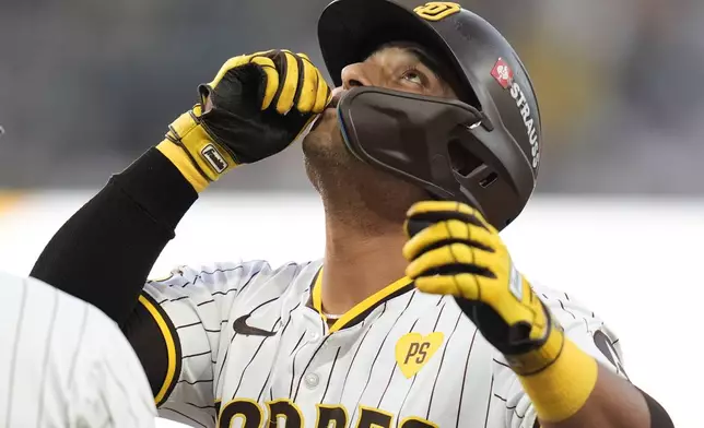 San Diego Padres' Donovan Solano reacts after connecting for a single during the second inning in Game 1 of an NL Wild Card Series baseball game against the Atlanta Braves, Tuesday, Oct. 1, 2024, in San Diego. (AP Photo/Gregory Bull)