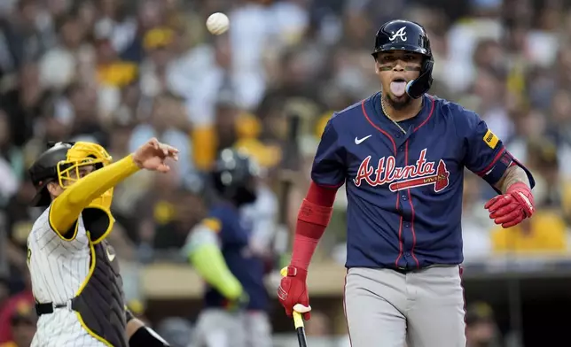 Atlanta Braves' Orlando Arcia reacts after dodging an inside pitch during the third inning in Game 1 of an NL Wild Card Series baseball game against the San Diego Padres, Tuesday, Oct. 1, 2024, in San Diego. (AP Photo/Gregory Bull)