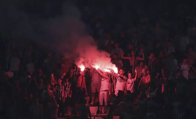 Fans of Brazil's Atletico Mineiro light flares as they celebrate their team's 3-0 victory over Argentina's River Plate in a Copa Libertadores semifinal first leg soccer match at MRV arena in Belo Horizonte, Brazil, Tuesday, Oct. 22, 2024. (AP Photo/Thomas Santos)