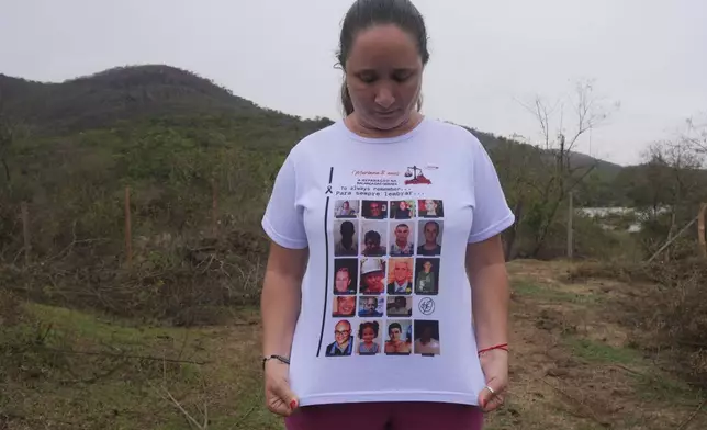 Monica dos Santos, 39, wears a T-shirt with the photos of victims of a dam break in Bento Rodrigues, Minas Gerais state, Brazil, Oct. 19, 2024. Victims of Brazil’s worst environmental disaster, on Nov. 5, 2015, took their case for compensation to a UK court on Monday, Oct. 21, 2024, almost nine years after tons of toxic mining waste poured into a major waterway, killing 19 people and devastating local communities. (AP Photo/Eleonore Hughes)