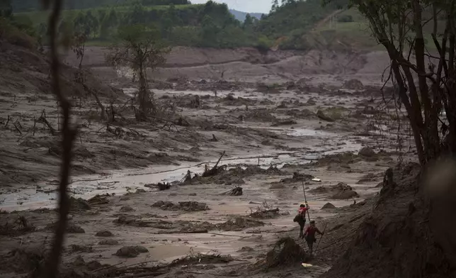 FILE - Rescue workers search for victims in Bento Rodrigues, Brazil, two days after a tsunami of mud, caused by a dam break, engulfed the town in the state of Minas Gerais, Nov. 8, 2015. (AP Photo/Felipe Dana, File)