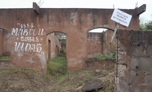 What remains of a home that was destroyed when a dam broke carries signs that read in Portuguese "That marked our lives" and "So that it is never forgotten" in Bento Rodrigues, Minas Gerais state, Brazil, Oct. 19, 2024. Victims of Brazil’s worst environmental disaster, on Nov. 5, 2015, took their case for compensation to a UK court on Monday, Oct. 21, 2024, almost nine years after tons of toxic mining waste poured into a major waterway, killing 19 people and devastating local communities. (AP Photo/Eleonore Hughes)