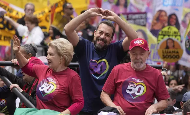 Mayoral candidate Guilherme Boulos of the Socialism and Liberty Party, center, gestures to supporters as he campaigns with Brazilian President Luiz Inacio Lula da Silva, right, and his running mate Marta Suplicy, left, the day before elections in Sao Paulo, Saturday, Oct. 5, 2024. (AP Photo/Andre Penner)