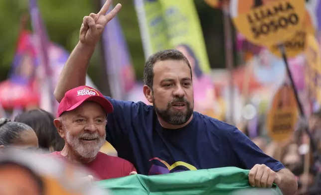 Mayoral candidate Guilherme Boulos of the Socialism and Liberty Party, right, campaigns with Brazilian President Luiz Inacio Lula da Silva the day before elections in Sao Paulo, Saturday, Oct. 5, 2024. (AP Photo/Andre Penner)