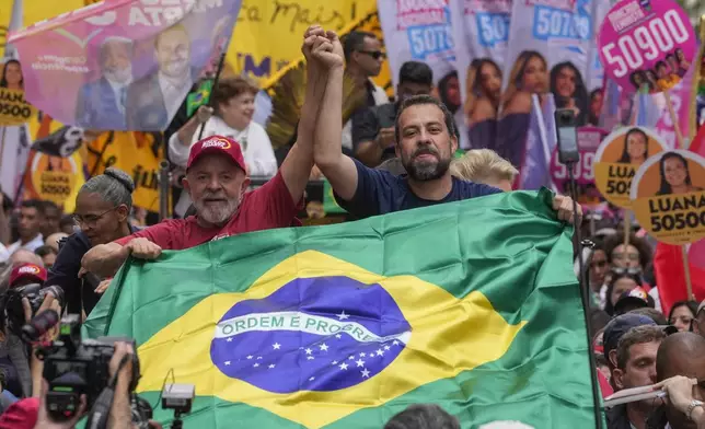 Brazilian President Luiz Inacio Lula da Silva, left, campaigns with mayoral candidate Guilherme Boulos of the Socialism and Liberty Party the day before elections in Sao Paulo, Saturday, Oct. 5, 2024. (AP Photo/Andre Penner)